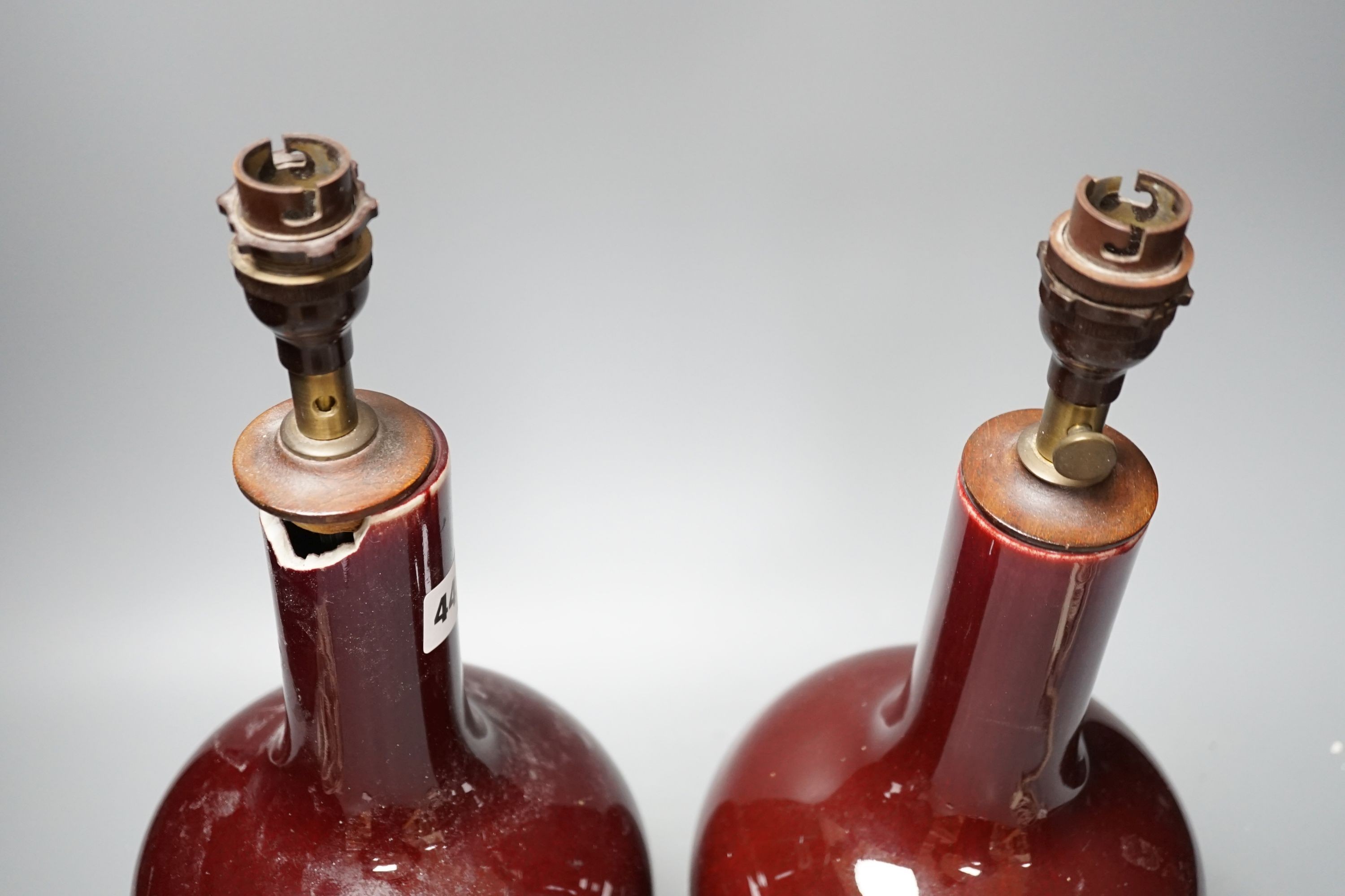 A pair of Chinese sang de boeuf glazed vases, converted to table lamps (a.f.)